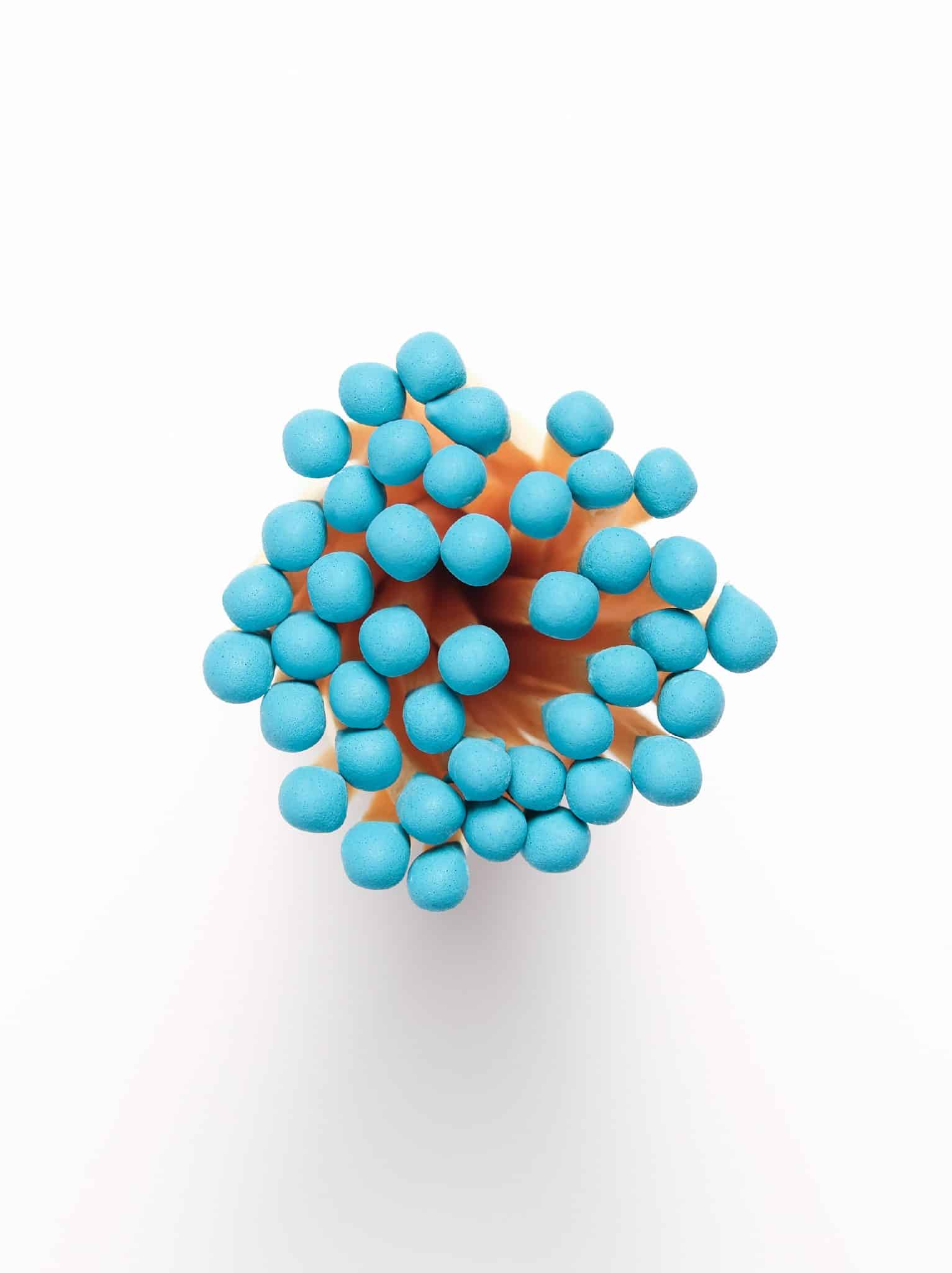 Overhead image of Made Market matchsticks with aqua colored tips