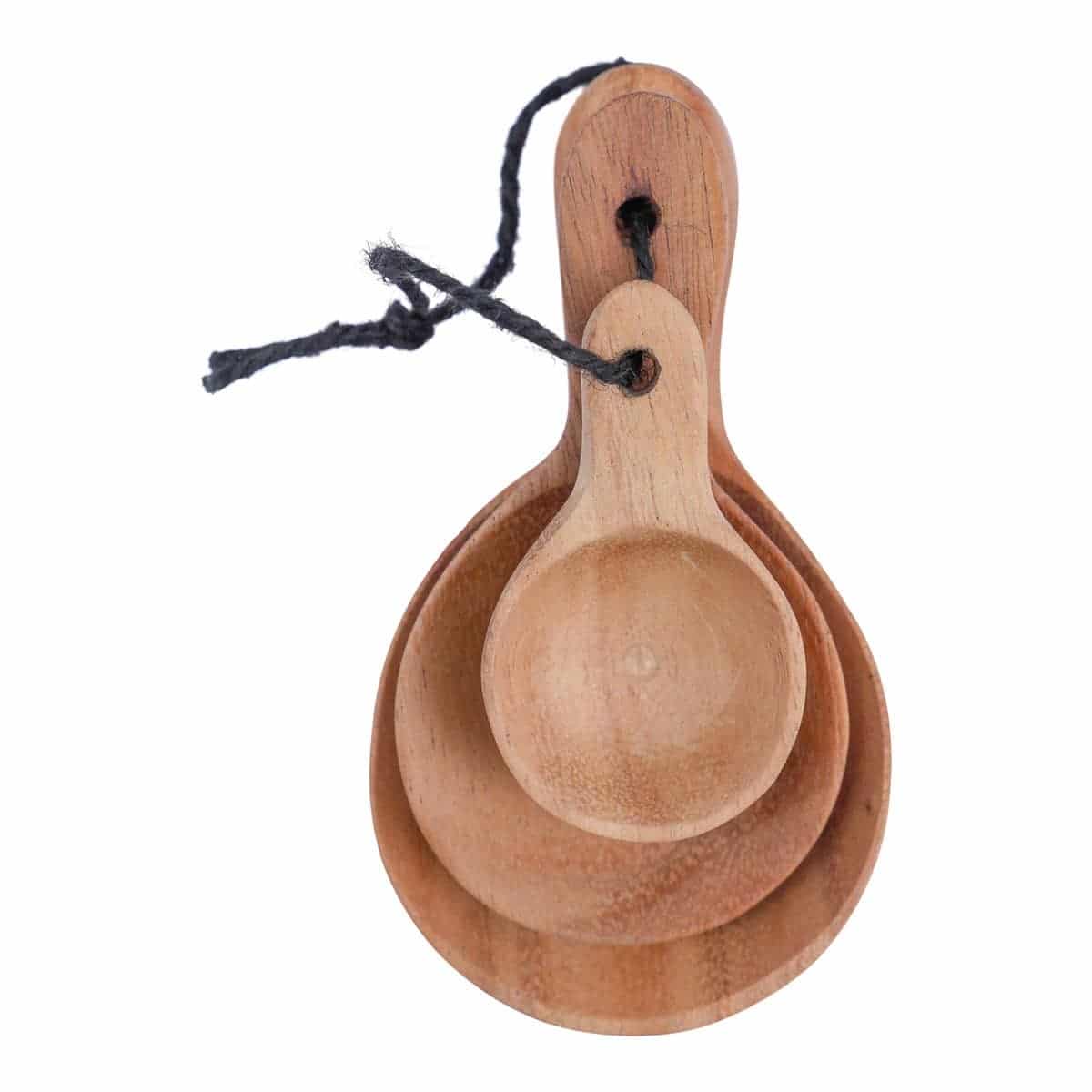 Set of small carved wood spoons stacked by size and tied together with black twine.