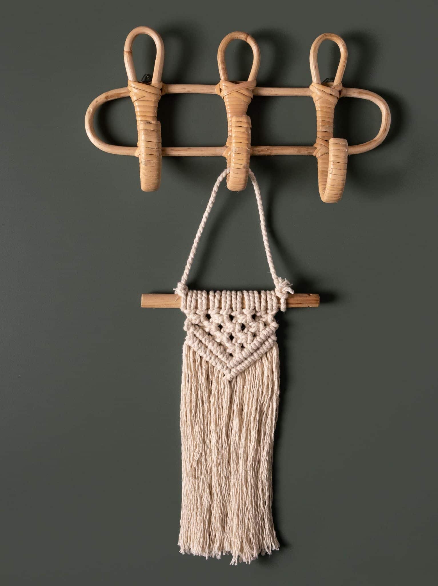 Rattan Wall Hanging Hooks with a Small Macrame Wall Hanging displayed on a dark green wall.