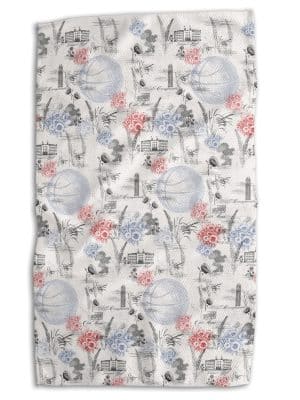 KU 1912 Basketball Tea Towel with vintage sketch artwork of Kansas landmarks, basketballs, and florals in red and blue, double-sided microfiber.
