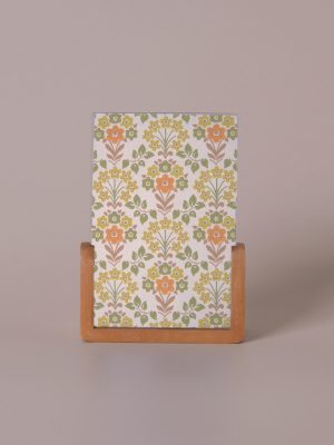 Vertical wood photo frame with floral patterned insert in warm earth tones.
