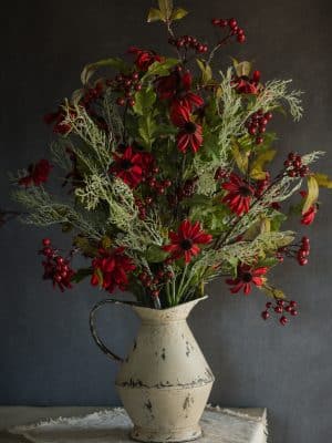 Large arrangement featuring Red Chateau Black Eyed Susan Pick with greenery and berries in a rustic cream pitcher vase.