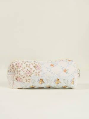 Small quilted floral makeup bag with pastel patchwork design and zipper closure