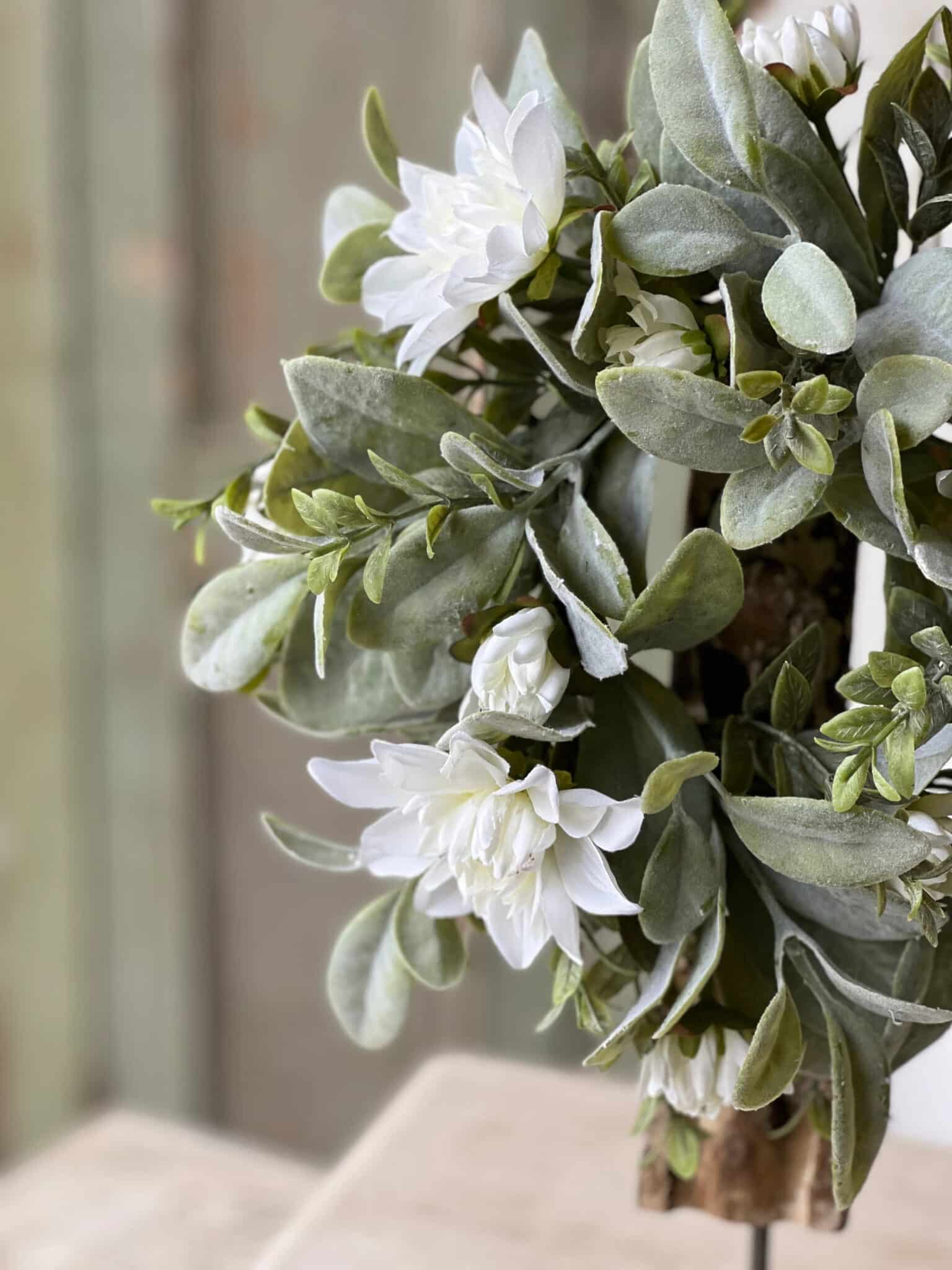 Close-up of White Cottage Blooms Candle Ring featuring realistic white florals and muted green foliage