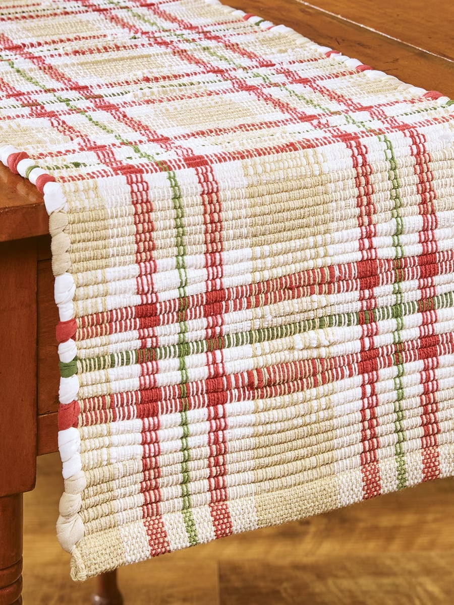 be-made-hays-ks-cozy-christmas-chindi-table-runner-edge-view Side view of the Cozy Christmas Chindi Table Runner draped over a table, showing the woven plaid pattern.