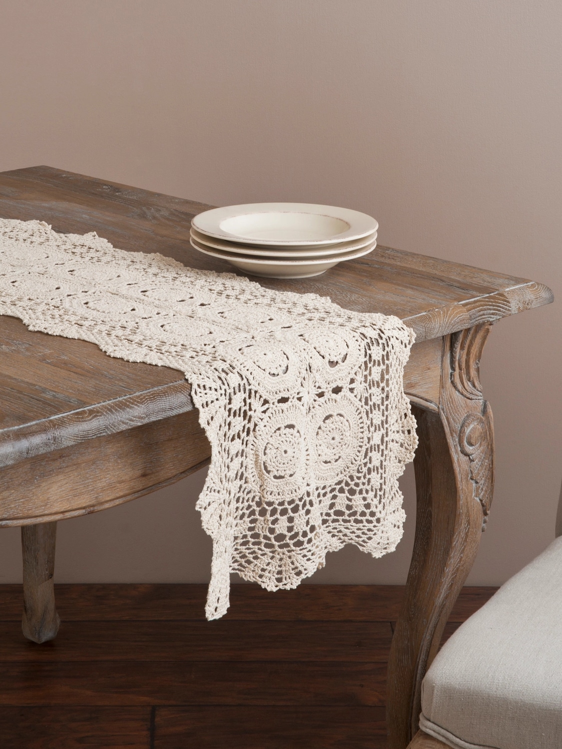 be-made-hays-ks-vintage-cream-crochet-lace-table-runner-styled Ecru cotton crochet lace table runner styled across a rustic wood table, highlighting its delicate pattern and classic vintage appeal.
