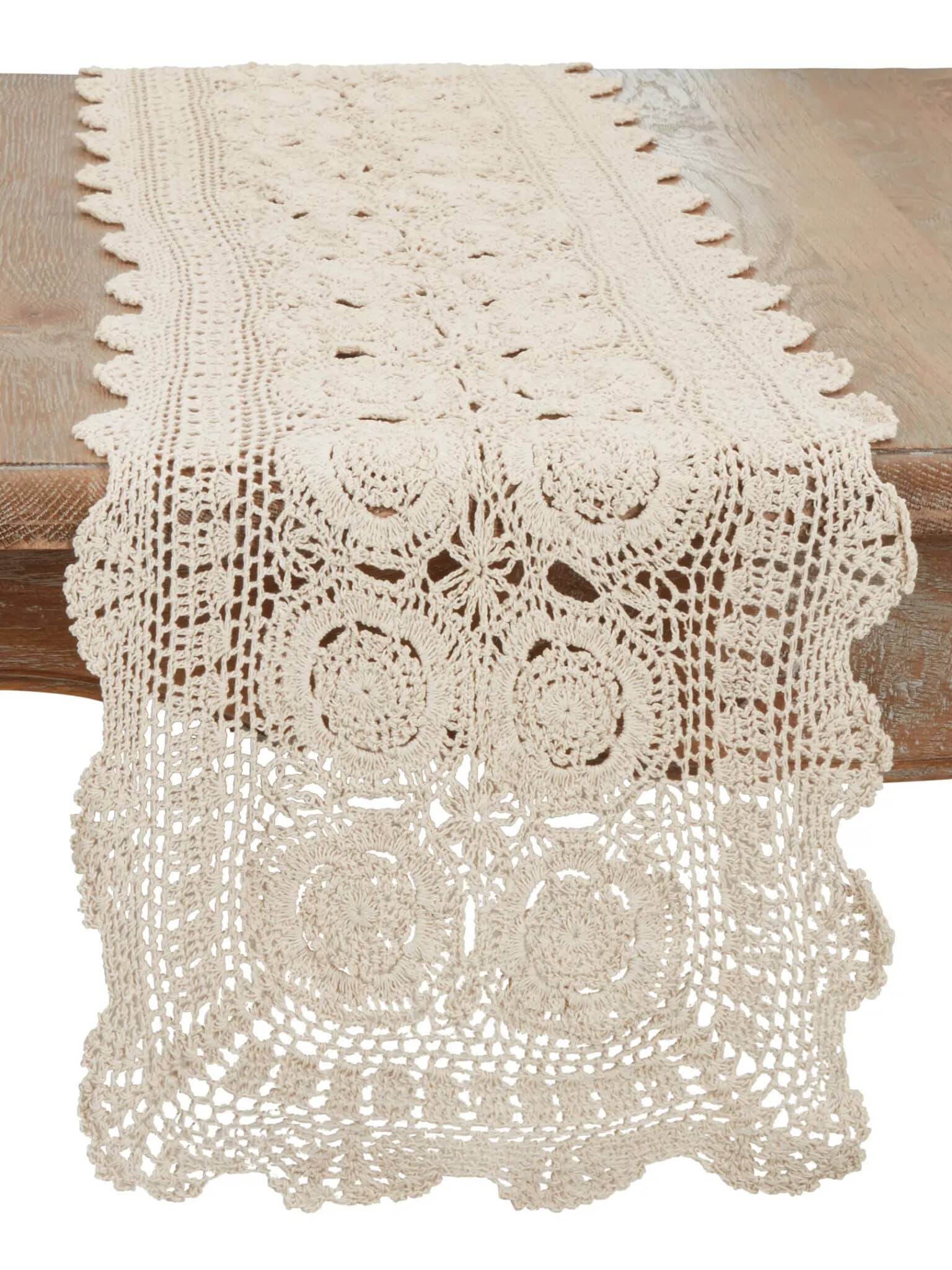 Vintage Cream Crochet Lace Table Runner in ecru cotton featuring an intricate openwork pattern draped over the edge of a wood table.