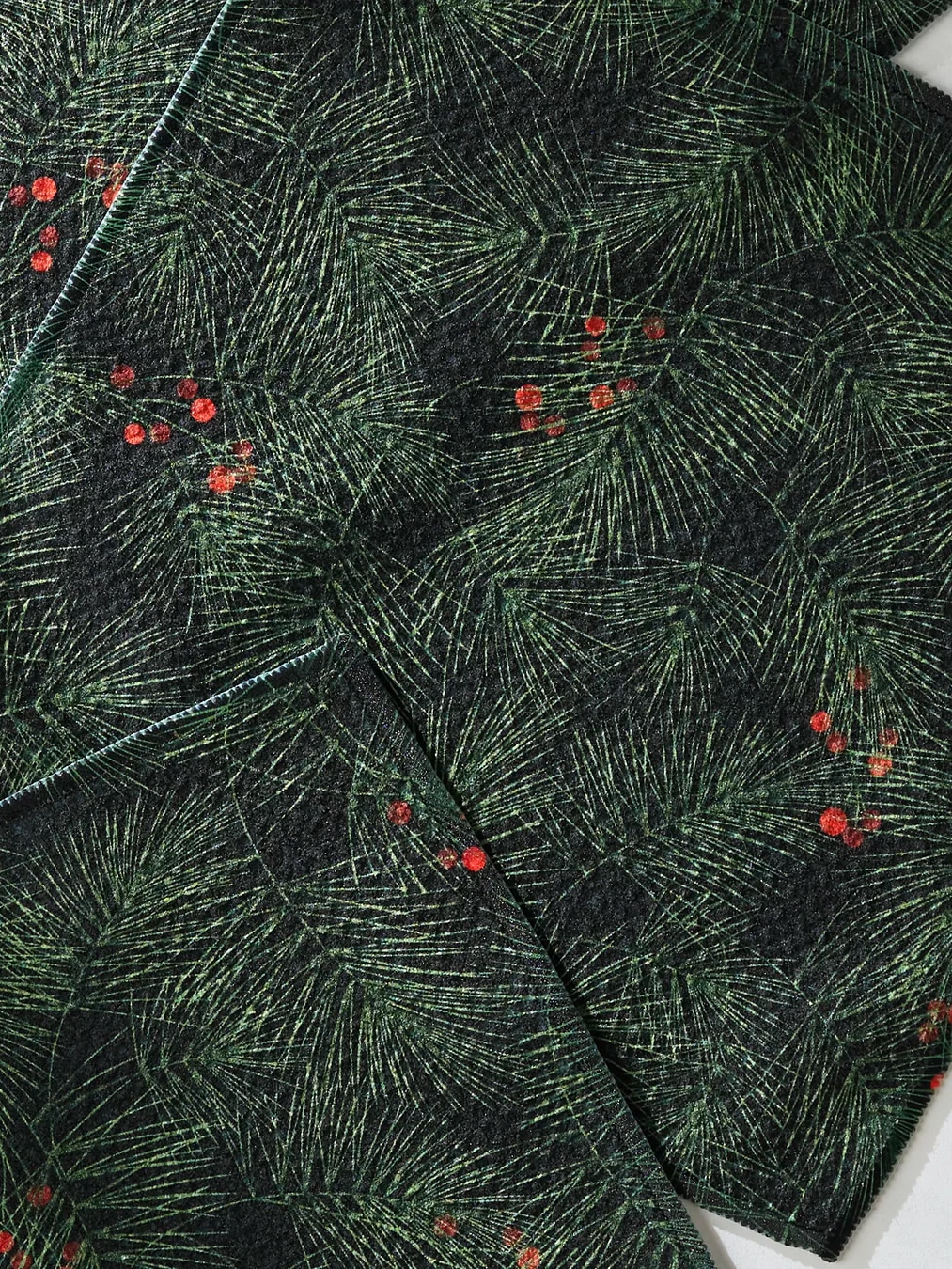 Evergreen Pine Geometry Dishcloth set arranged in a flat lay showing the deep green pine needle pattern with small red berries.