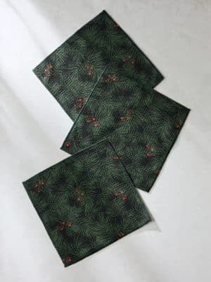 Three Evergreen Pine Geometry Dishcloths displayed on a white surface, highlighting the dark green pine pattern and red berry accents.