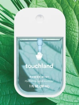 Touchland Frosted Mint Power Mist Hand Sanitizer shown against a green leaf background.