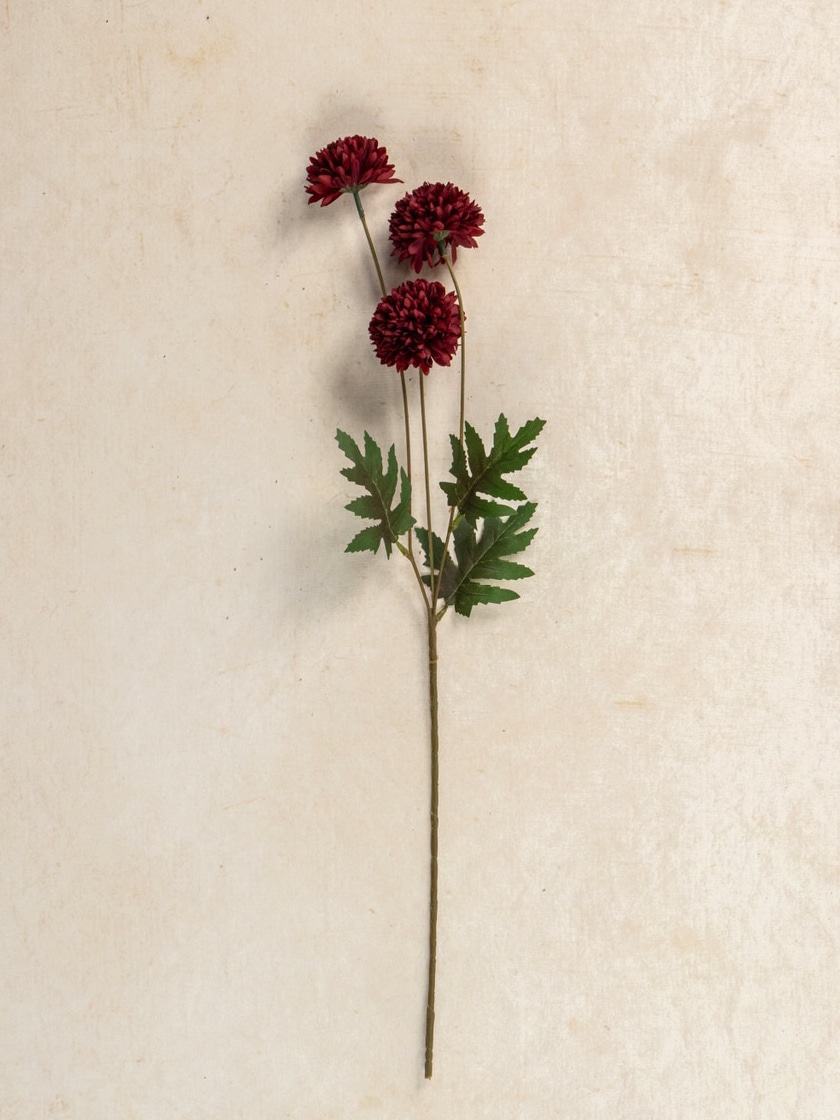 Single 24″ Burgundy Pom Pom Spray showcasing multiple faux blooms and green leaves against a neutral backdrop.