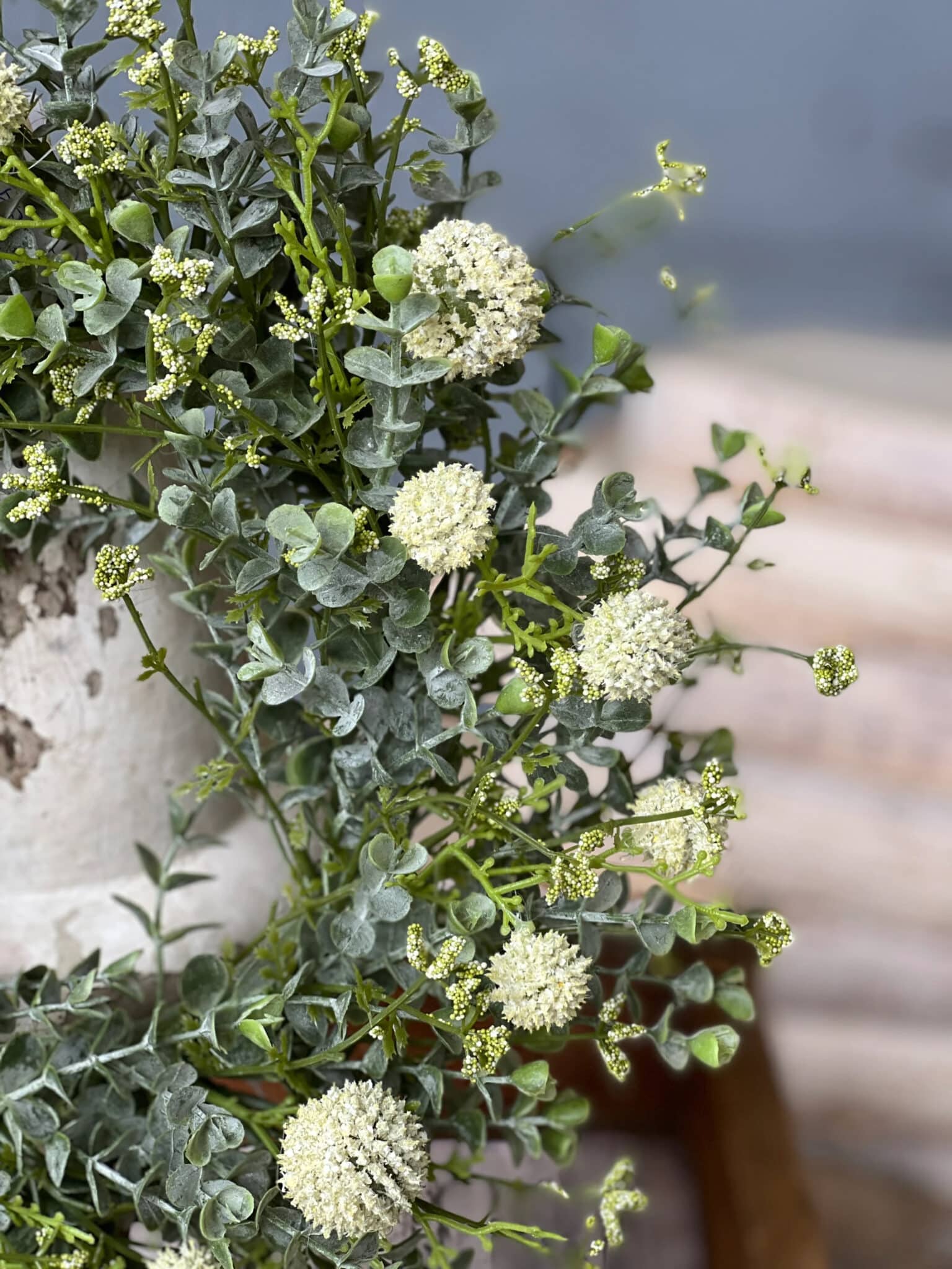 White Garden Allium Candle Ring featuring draping greenery and petite white allium blooms.