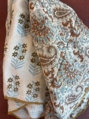 Close-up view of the Amber Floral Kitchen Towels highlighting the paisley floral pattern and lightweight gauze texture.