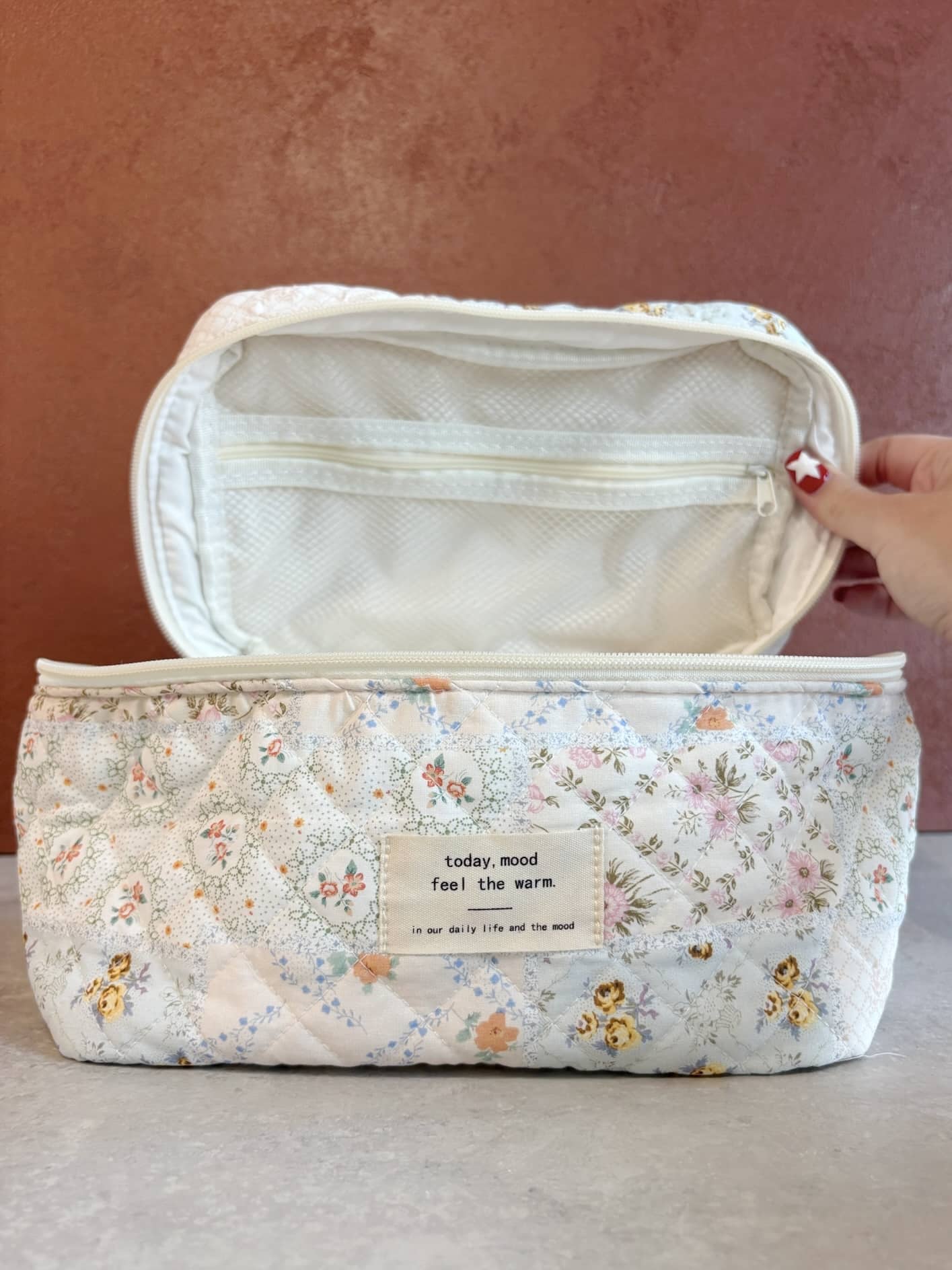 Open Quilted Floral Makeup Bag showing spacious interior and zippered mesh pocket for organizing toiletries or makeup.