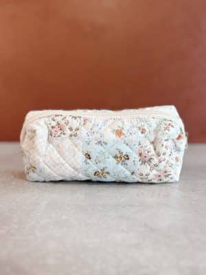 Front-facing image of the small quilted floral makeup bag, showcasing pastel patchwork and rounded silhouette.