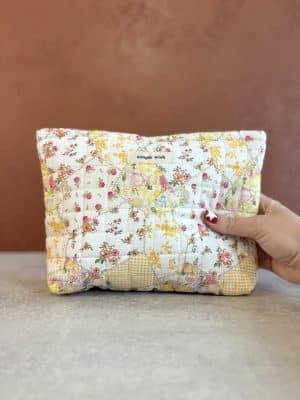 Front view of the Quilted Yellow Floral Makeup Bag showing cheerful floral patchwork design and soft quilted texture.