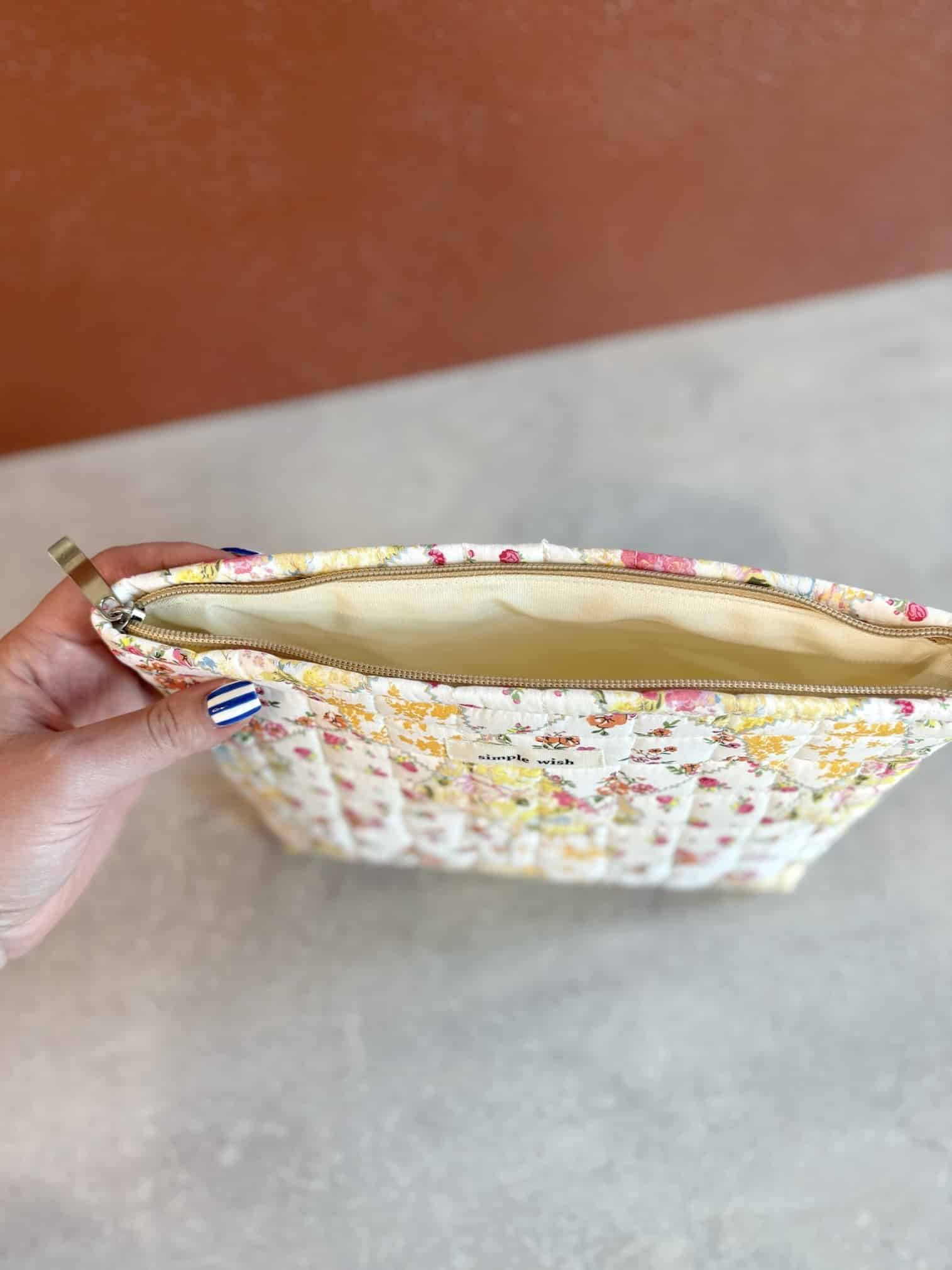 Top view of the Quilted Yellow Floral Makeup Bag with zipper open, revealing beige cotton canvas lining.