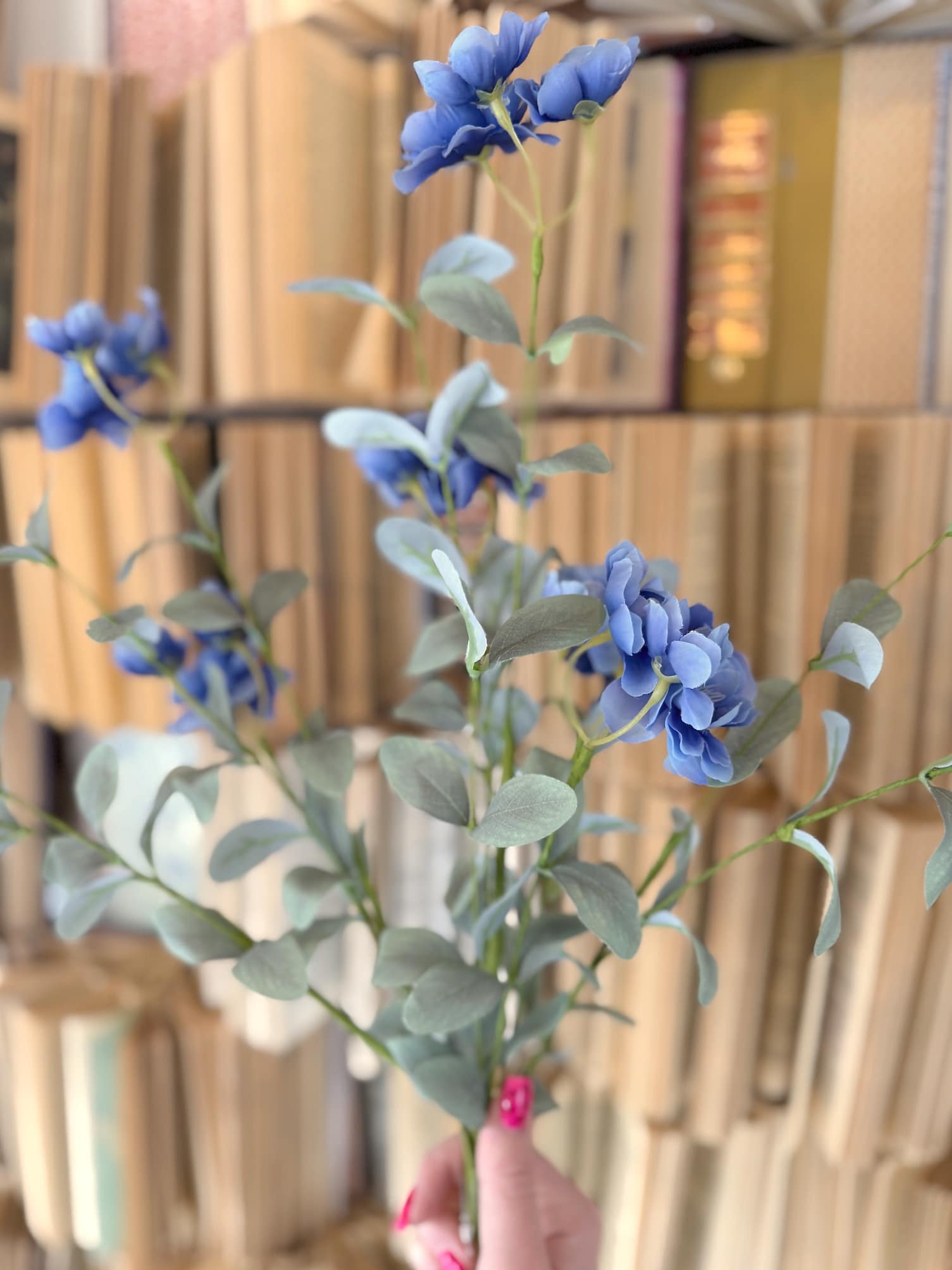 Close-up of blue blossom stems featuring detailed petals and airy greenery for a natural, garden-inspired look.
