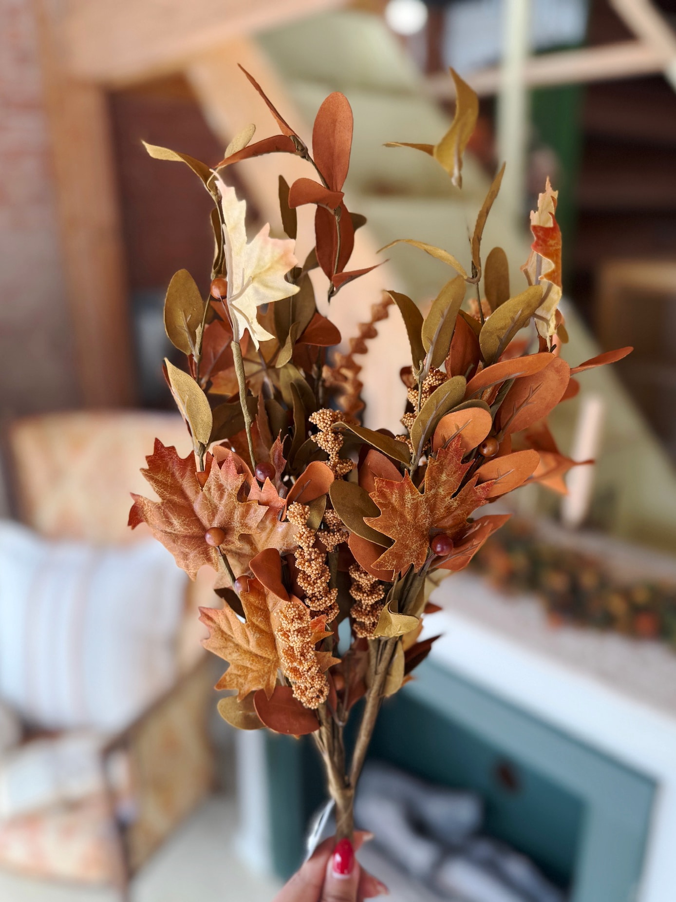 Maple & Walking Fern Pick displayed upright with a mix of textured foliage in earthy orange, gold, and brown hues.