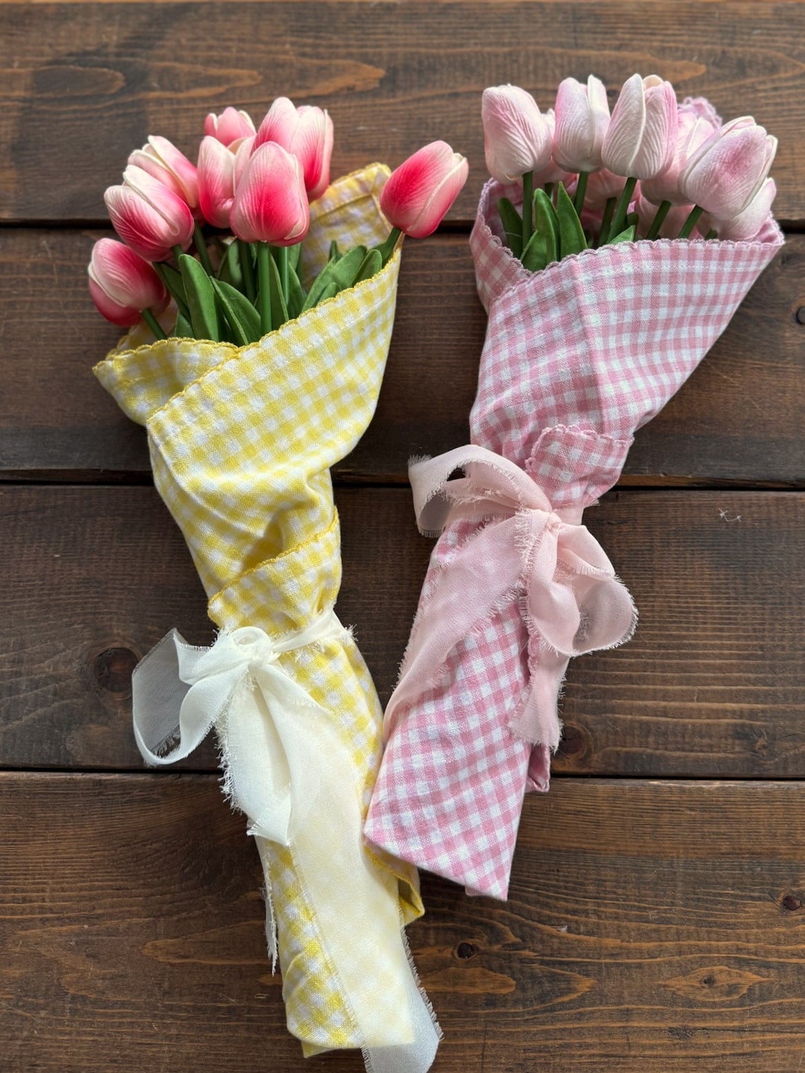 be-made-hays-ks-pink-and-yellow-gingham-tulip-bouquets Two faux tulip bouquets wrapped in pink and yellow gingham displayed side by side