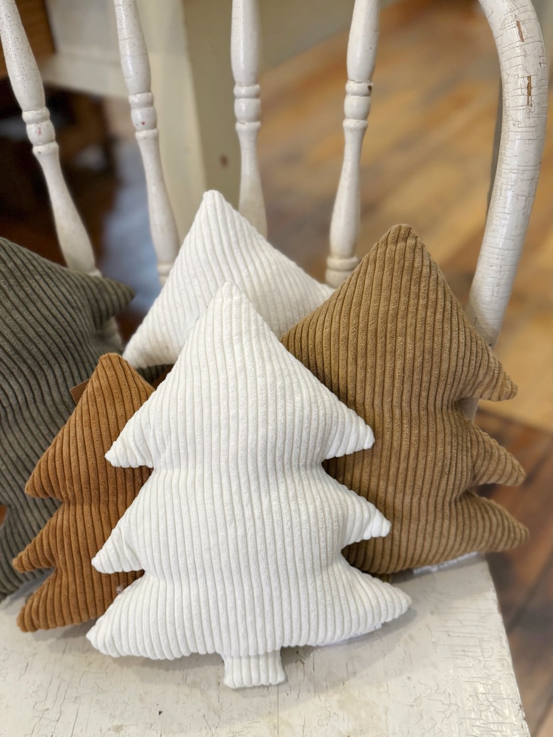 be-made-hays-ks-large-white-corduroy-stuffed-tree-pillow Large White Corduroy Stuffed Tree Pillows surrounded by camel and evergreen corduroy trees, adding soft neutral texture to a cozy holiday display.