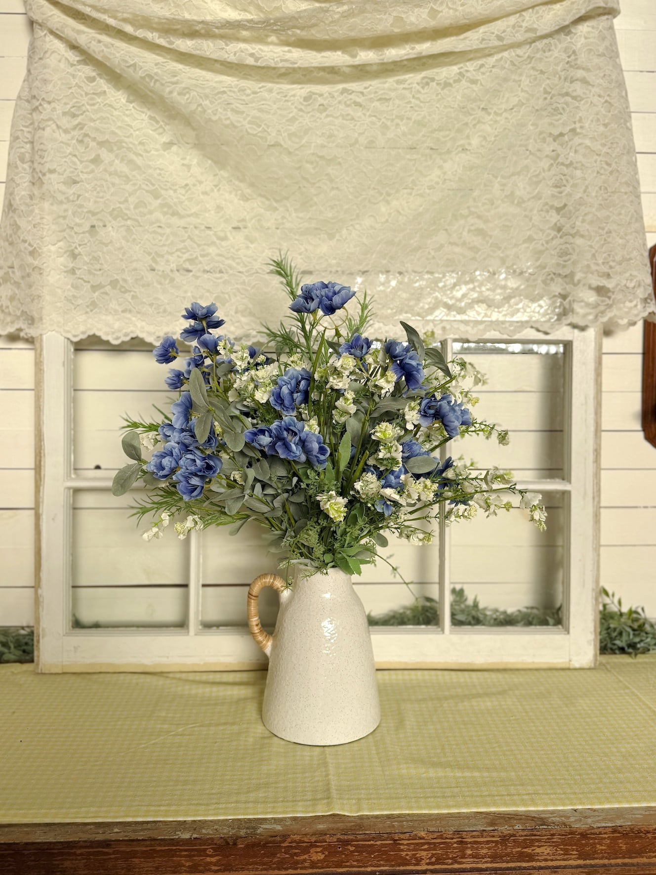 Small Off-White Vase With Rattan Handle Styled With Blue and White Florals