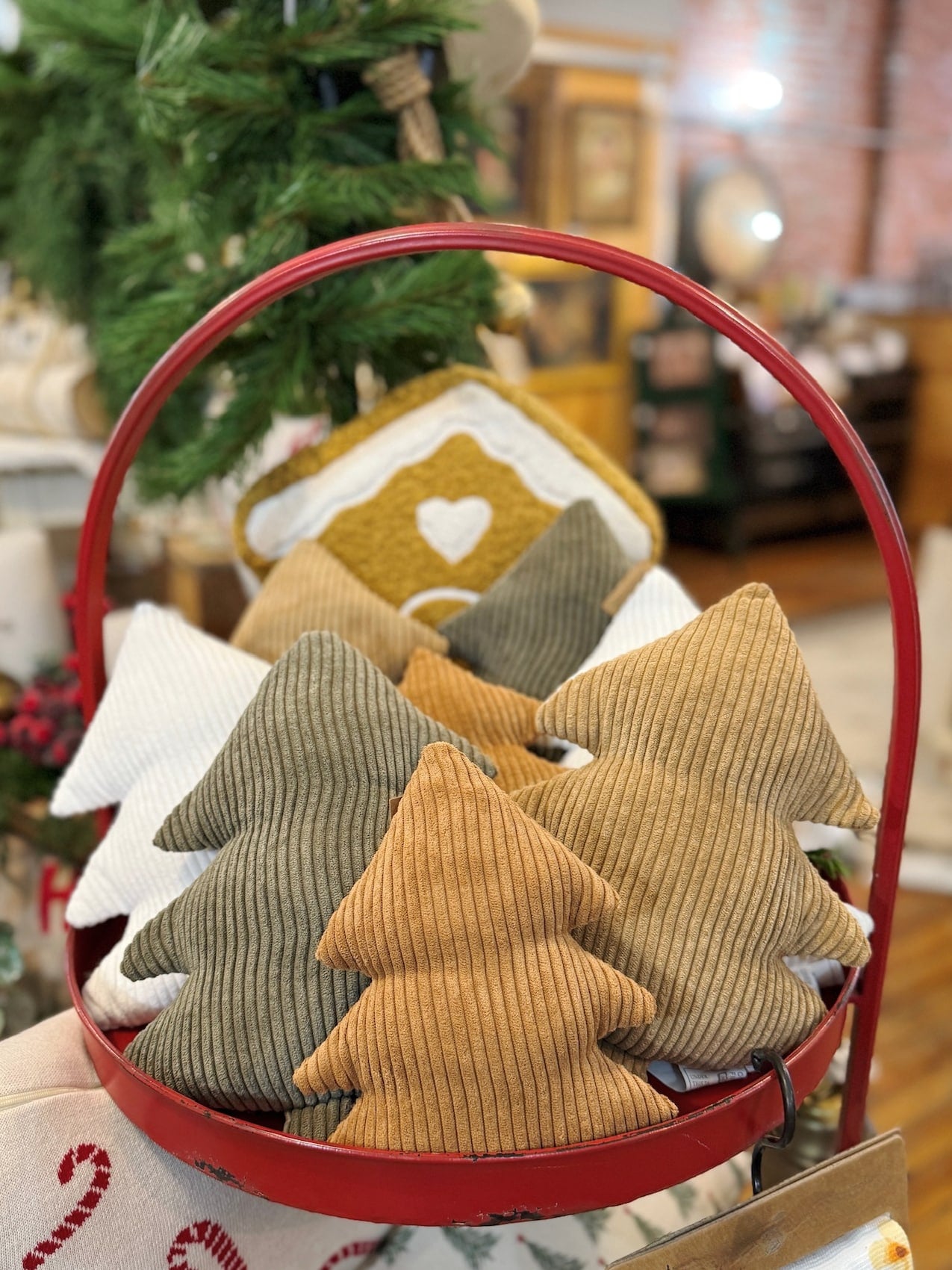 Assorted Corduroy Stuffed Trees in a red tray with holiday décor, featuring white, green, and neutral tones for a cozy Christmas display.