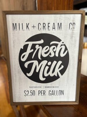 Farmhouse-style Fresh Milk sign with natural wood frame and classic black-and-white lettering.