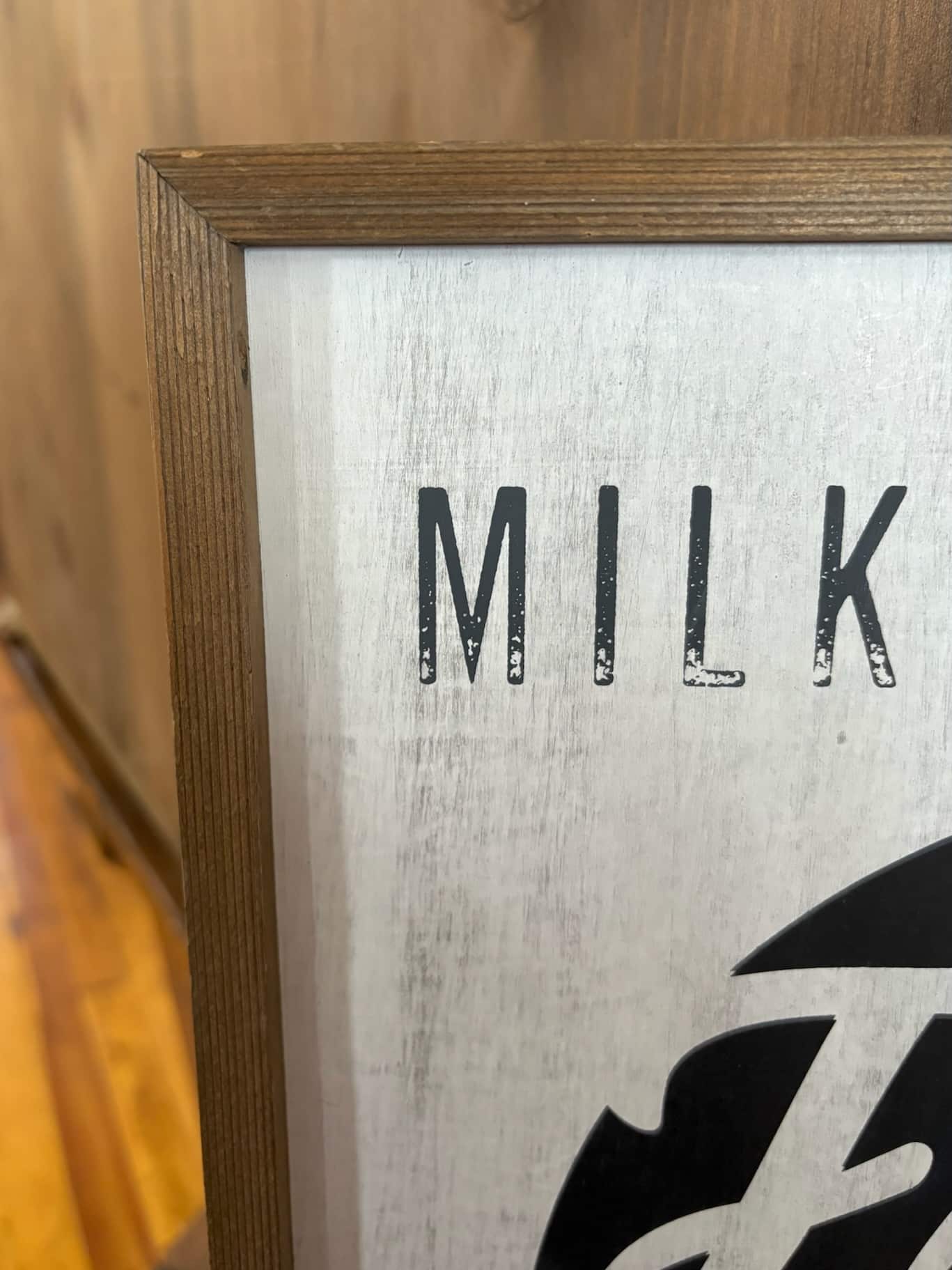 Vintage-style Fresh Milk sign with wood frame, black stamped circle, and whitewashed background.