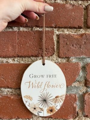 Oval wood ornament with wildflower illustration and “Grow Free Wildflower” text.