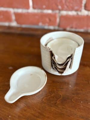Set of four mini stoneware tapas plates with reactive glaze and coordinating storage holder.