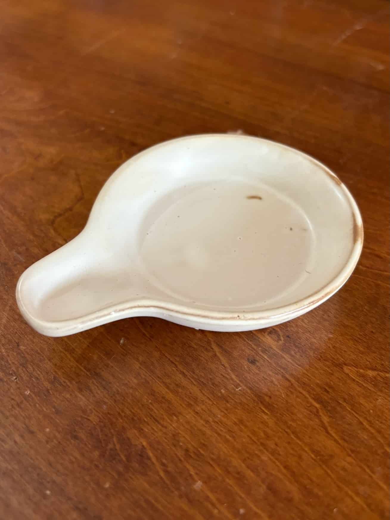 White stoneware tapas plates with reactive glaze and matching holder for serving snacks and charcuterie.