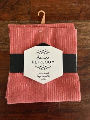 Folded clay linen dish towel with white stitched stripe from Heirloom Linen collection.