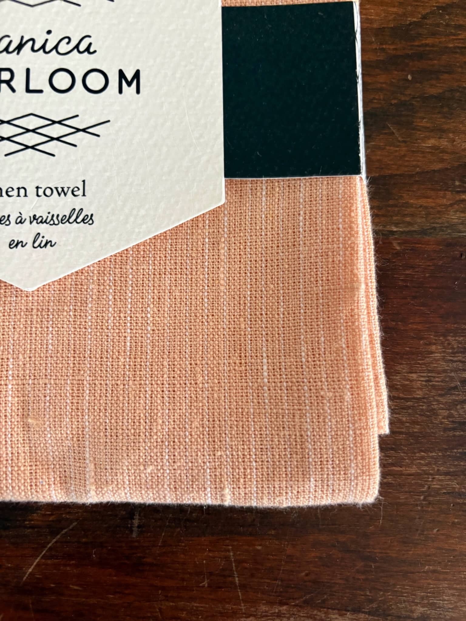 Blush pink heirloom linen dish towel with white stitched stripe.