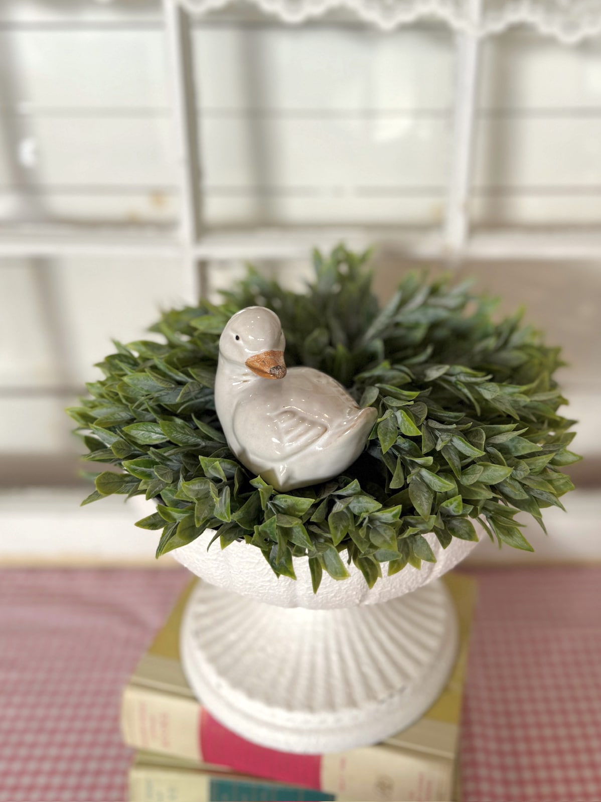 White Metal Pedestal Bowl Filled With Faux Greenery Half Sphere and Vintage Duckling Figurine