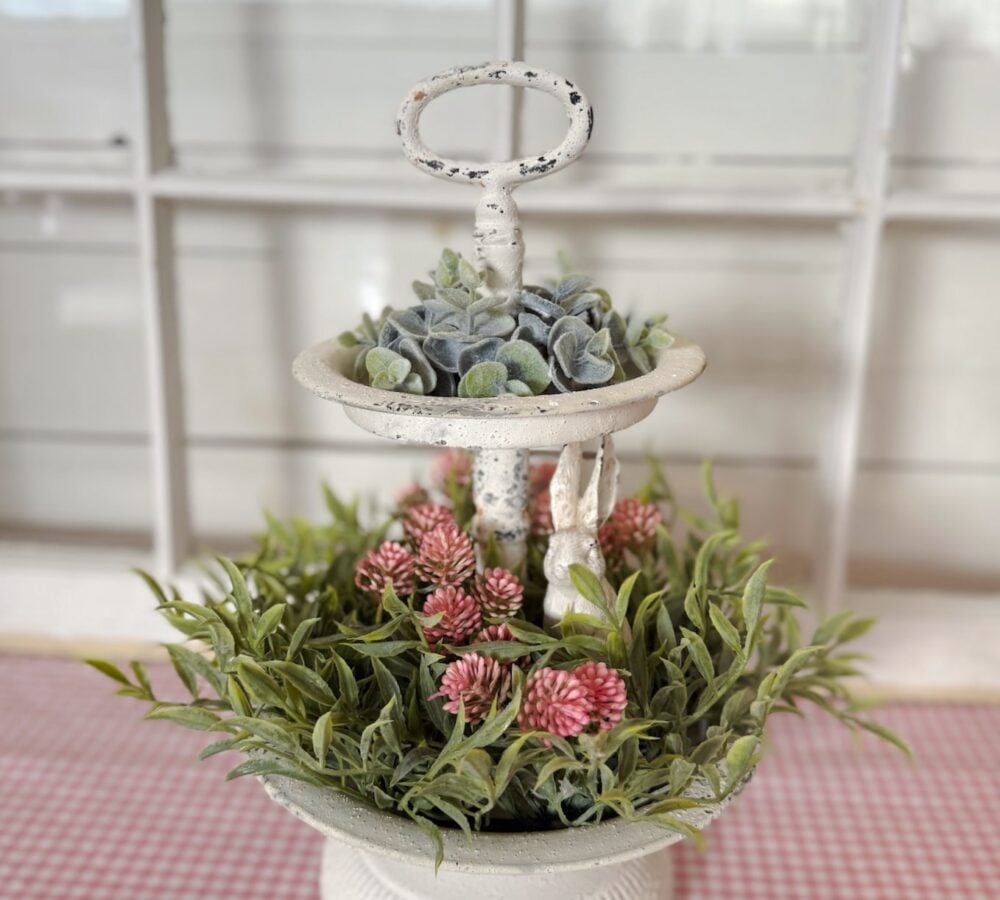 be-made-hays-ks-two-tiered-tray-candle-rings-bunny White Two Tiered Tray Styled With Pink Thimble Bud Candle Ring, Eucalyptus Ring, and White Cottage Bunny