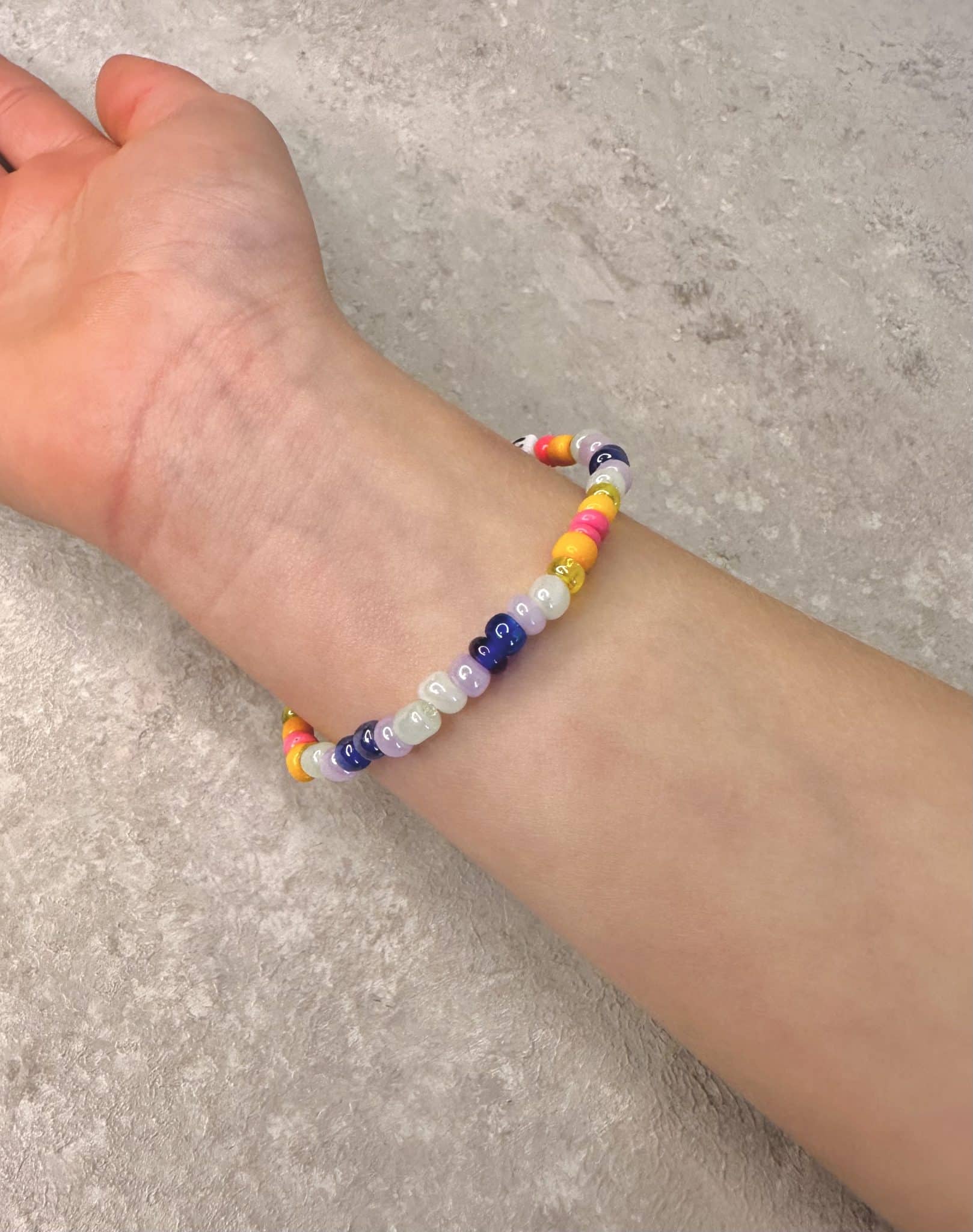 Back view of kids' Magic friendship bracelet showing vibrant multicolor beads on child's wrist.