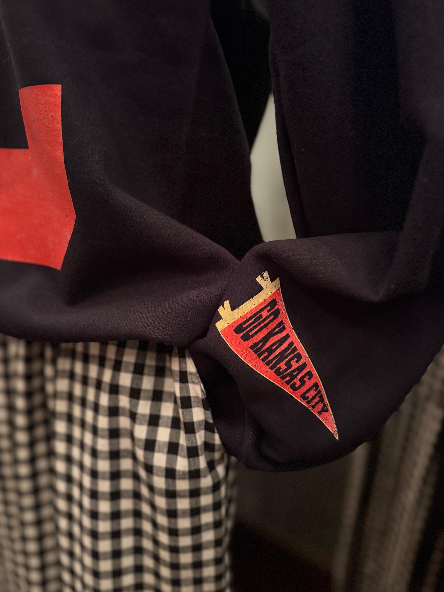 Close-up of the KC Icons Crewneck showing sleeve icon detail.