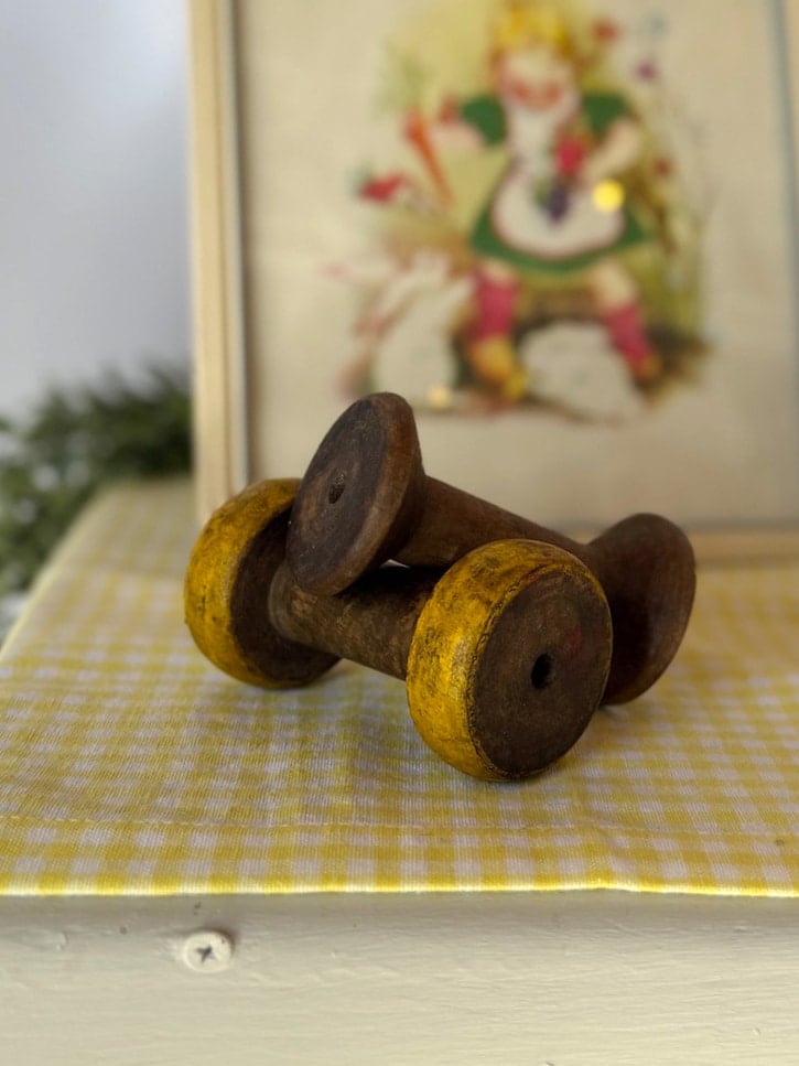 Reclaimed vintage wooden spool from India featuring aged patina and worn edges, styled as a rustic decorative accent.
