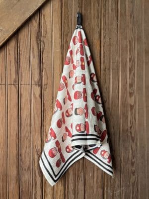 Chiefs Players Tea Towel with red and gold player illustrations hanging on a wooden wall.