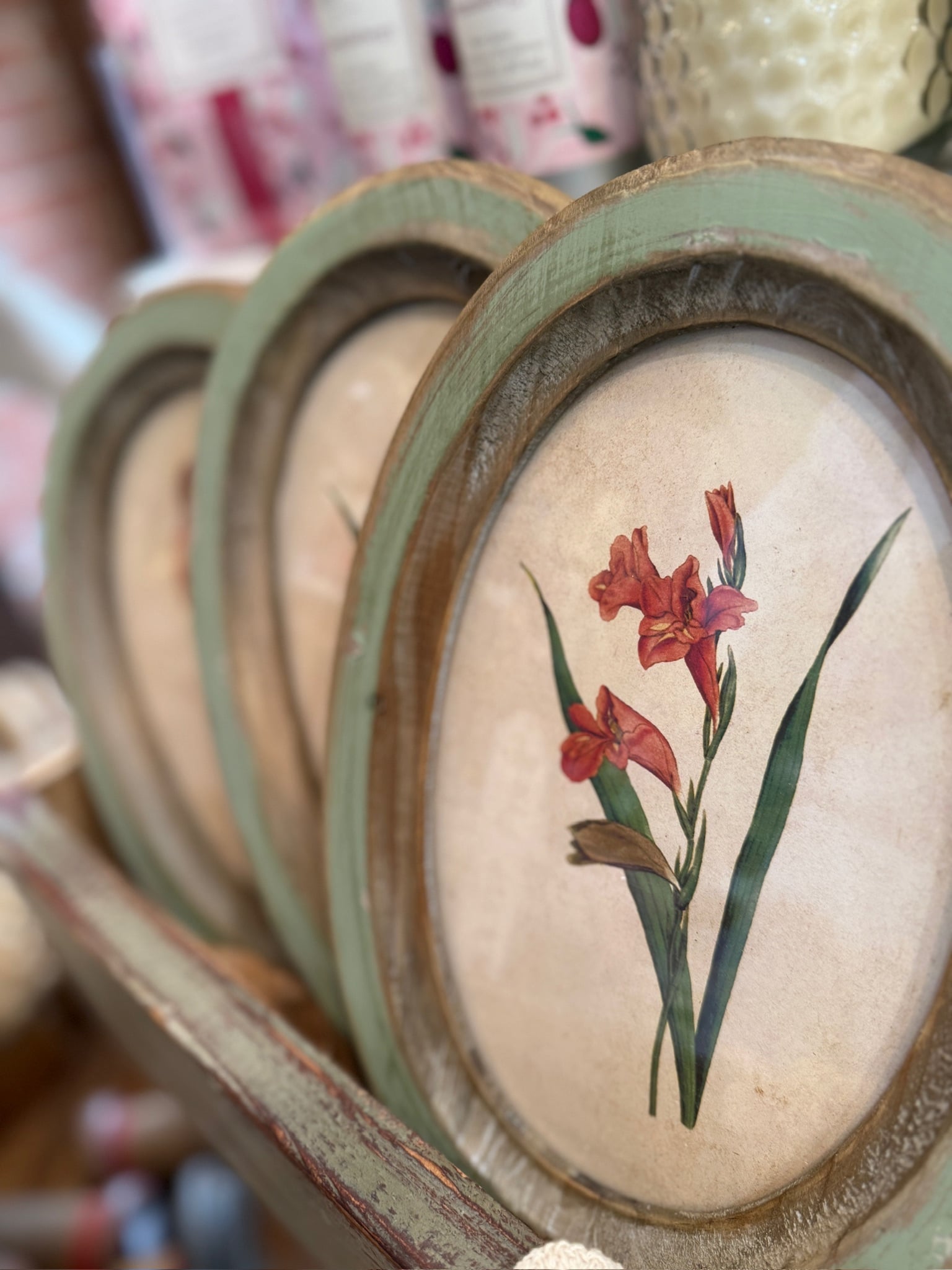 Oval Wood Framed Flower Wall Decor No. 5 with red floral botanical print in distressed green and natural wood frame.