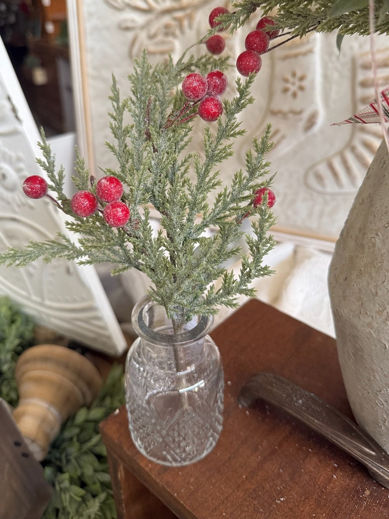 Glittered Pine Berries Floral Pick with frosted greenery and red berries styled in a clear pressed glass bud vase.