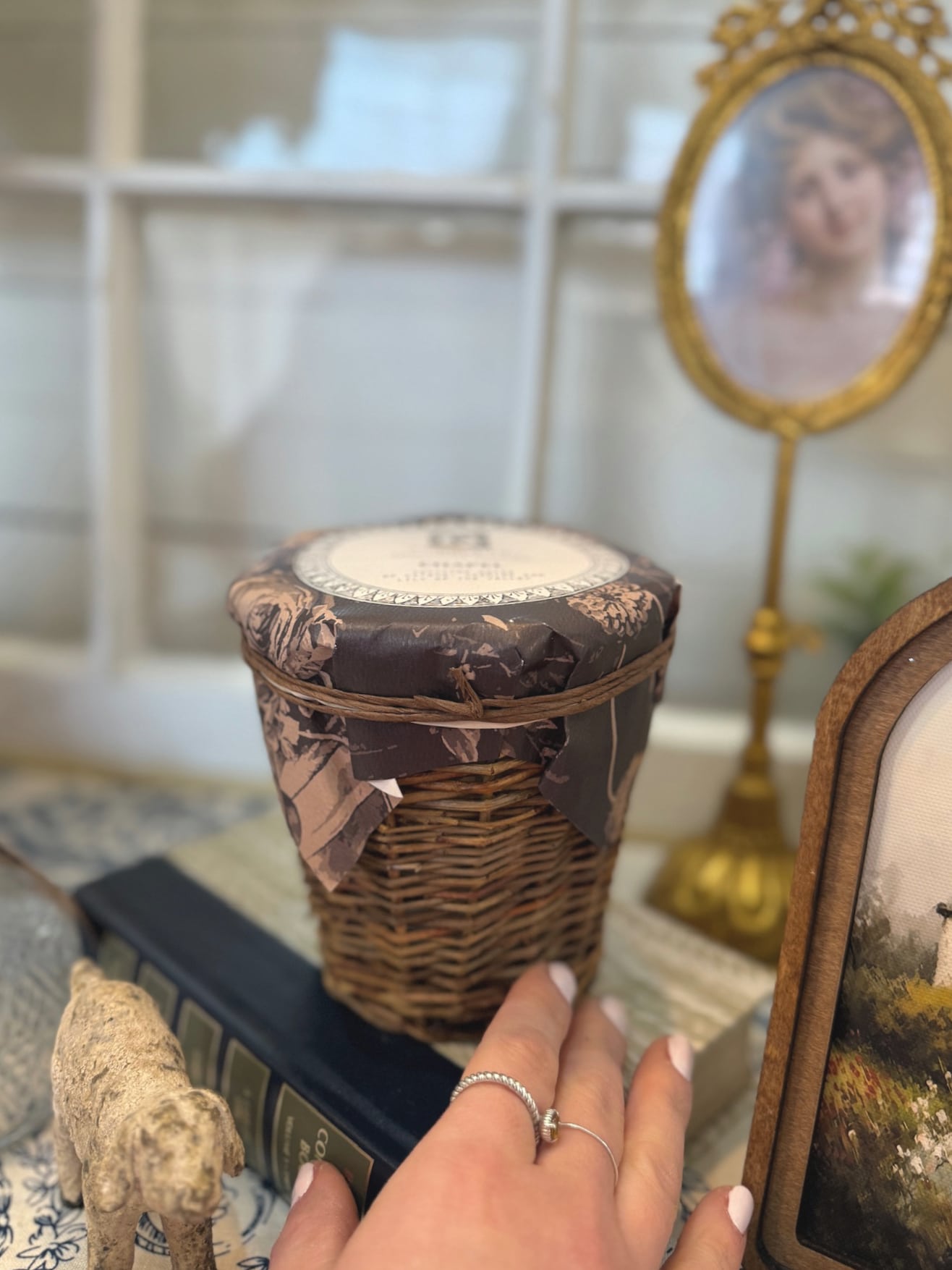 be-made-hays-ks-wicker-chapel-candle-side-view Wicker Chapel Candle in natural woven holder styled on stacked vintage books with gold mirror and cottage decor background