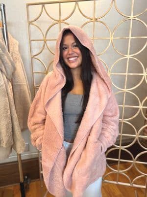 Model wearing Mauve Plush Fur Hooded Jacket with oversized hood and cozy faux fur design.