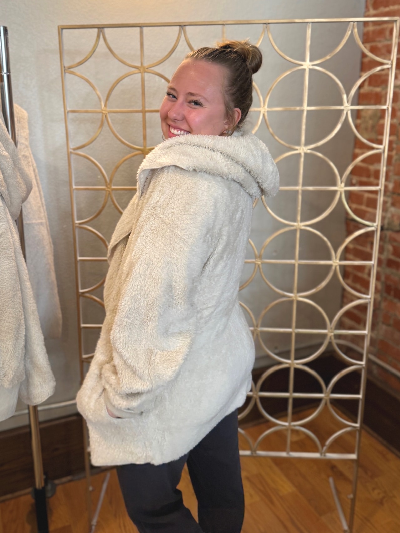 Side view of Warm Milk faux fur hooded jacket showing plush texture and relaxed fit.