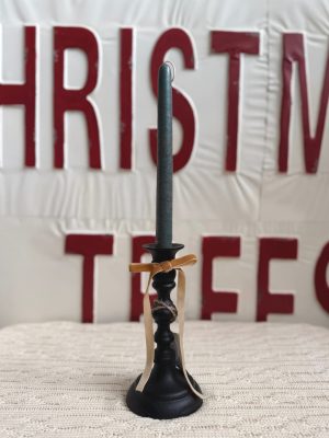 Black Empire Taper Candle Holder Small displayed with a green foliage taper candle and a tan velvet ribbon tied around the stem.