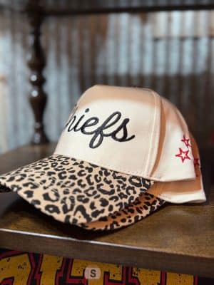Chiefs script trucker hat with cheetah-print brim stacked on display
