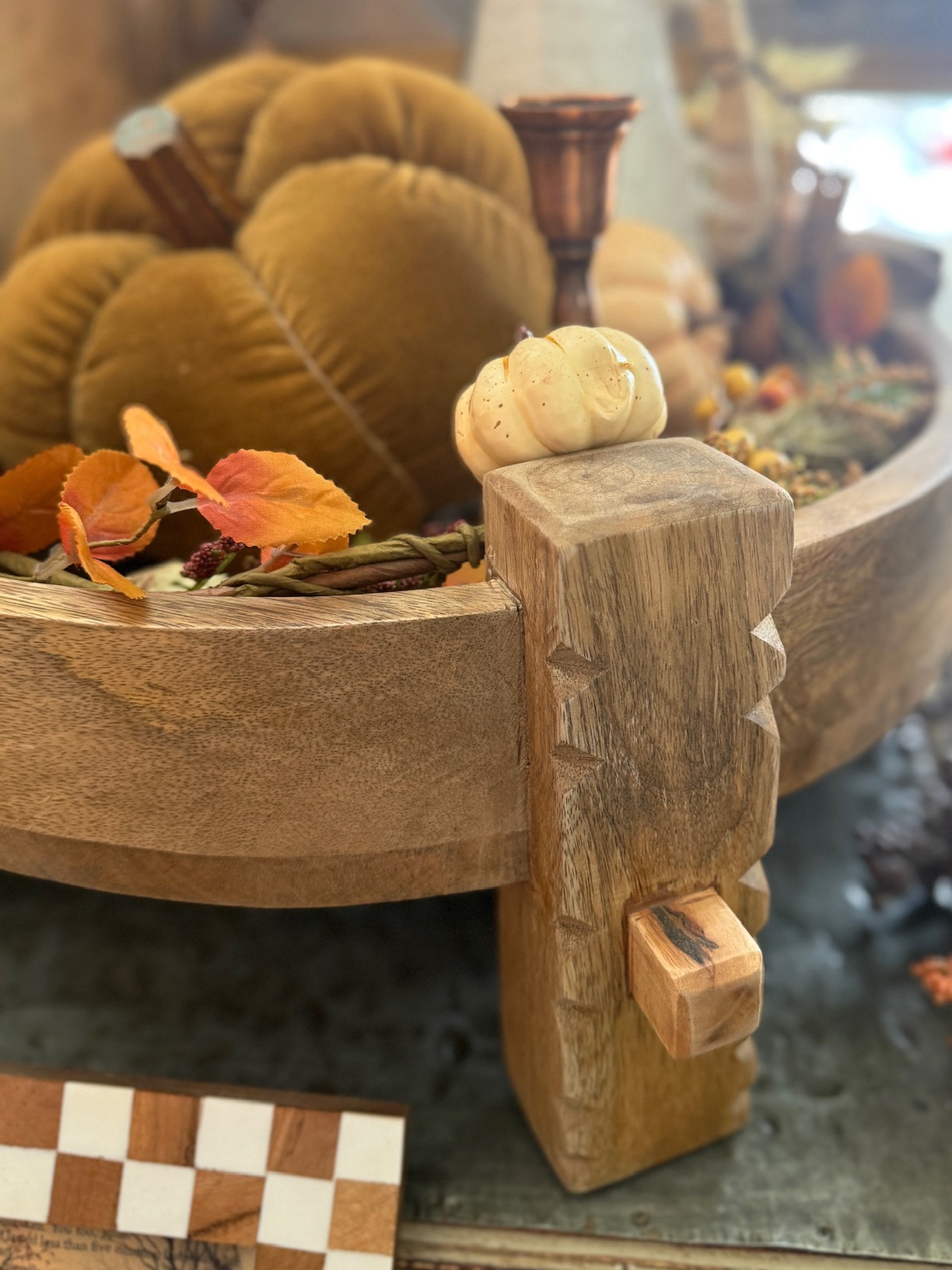 Natural wood chakki pedestal table with carved details and rustic autumn styling.