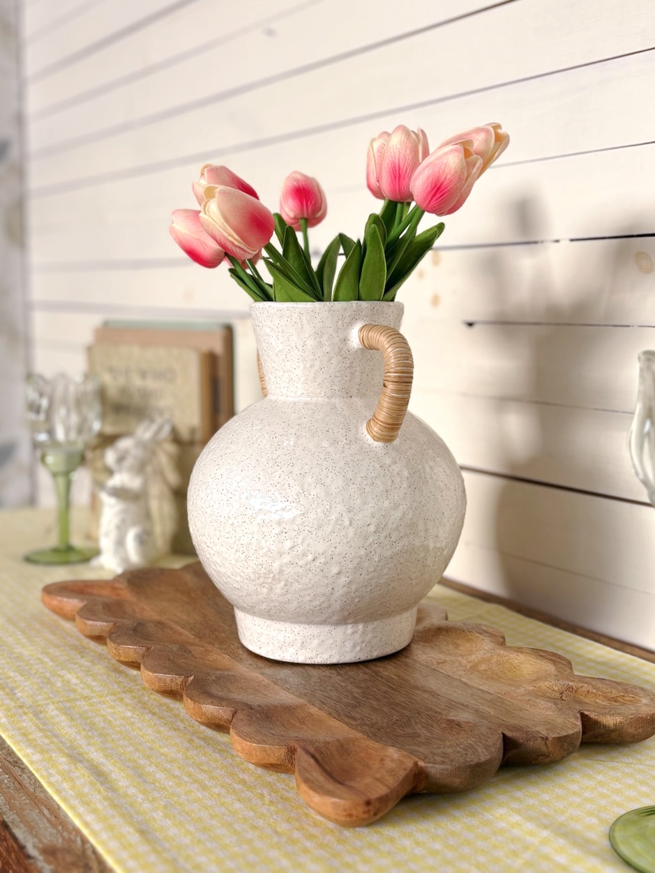 Rattan Wrapped Handle Vase Medium with Bright Pink Tulips styled on a wood board with spring decor.