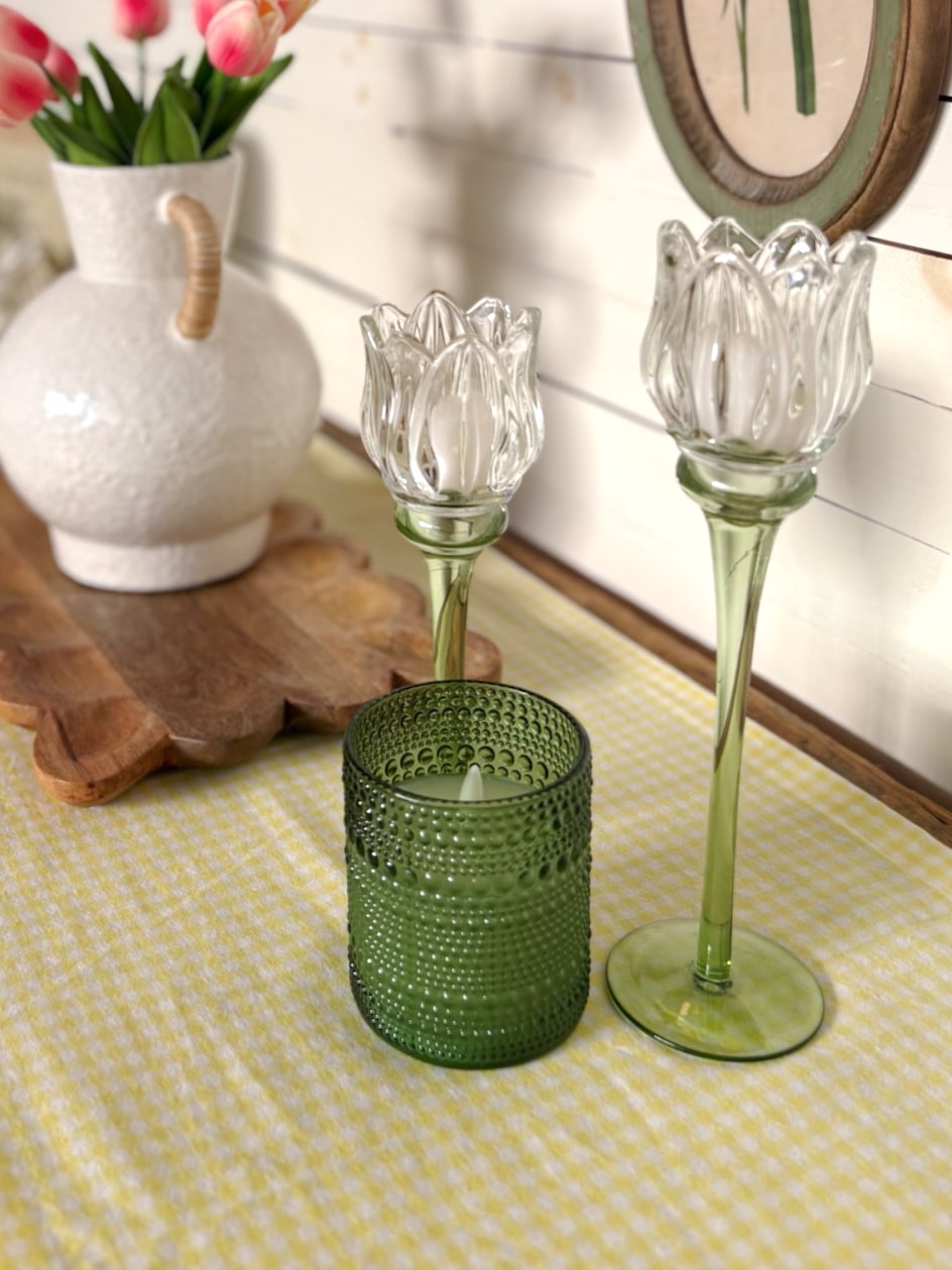 Top view of a small green dotted glass flameless candle with a soft LED glow.